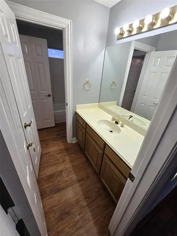 a bathroom with a sink a vanity and a mirror
