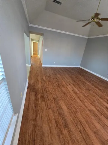 a view of a room with wooden floor and staircase