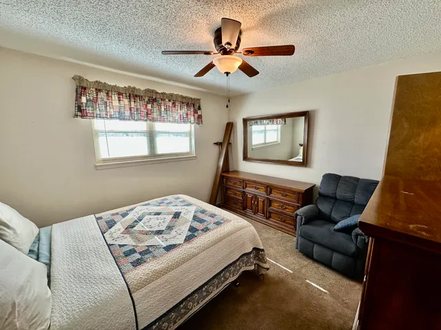 a bedroom with a bed window and couch