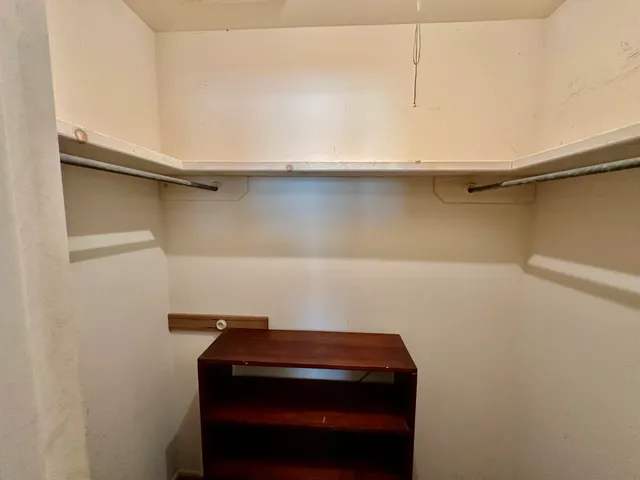 a small space with water heater on the wall