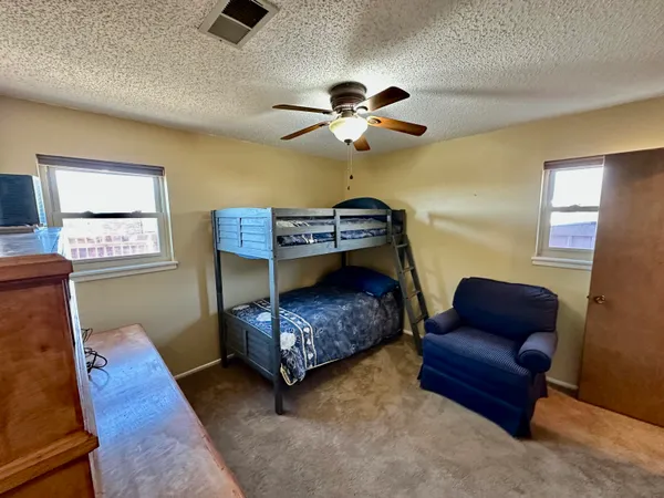 a bedroom with furniture and wooden floor