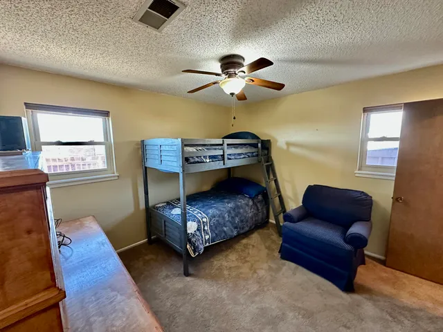 a bedroom with furniture and wooden floor