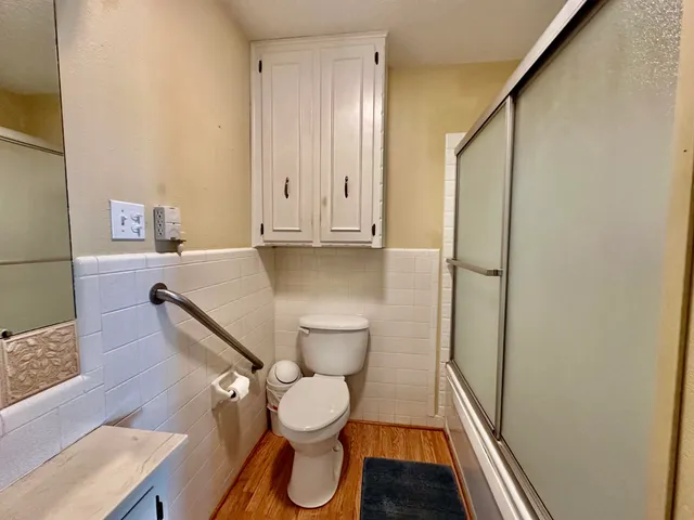 a white toilet sitting next to a bathroom sink