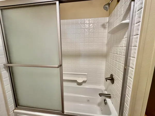 a bathroom with a glass shower door