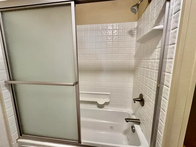 a bathroom with a glass shower door