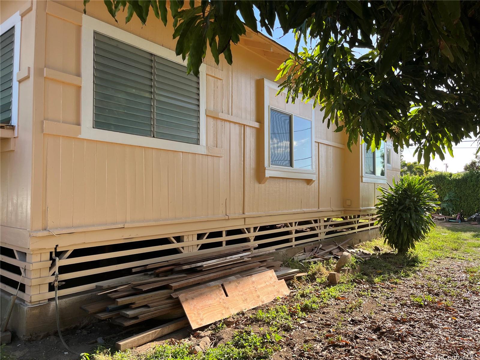 85-824 Lihue Street Waianae, HI 96792 - Photo 11 of 21 a backyard of a house with barbeque oven and table of chairs