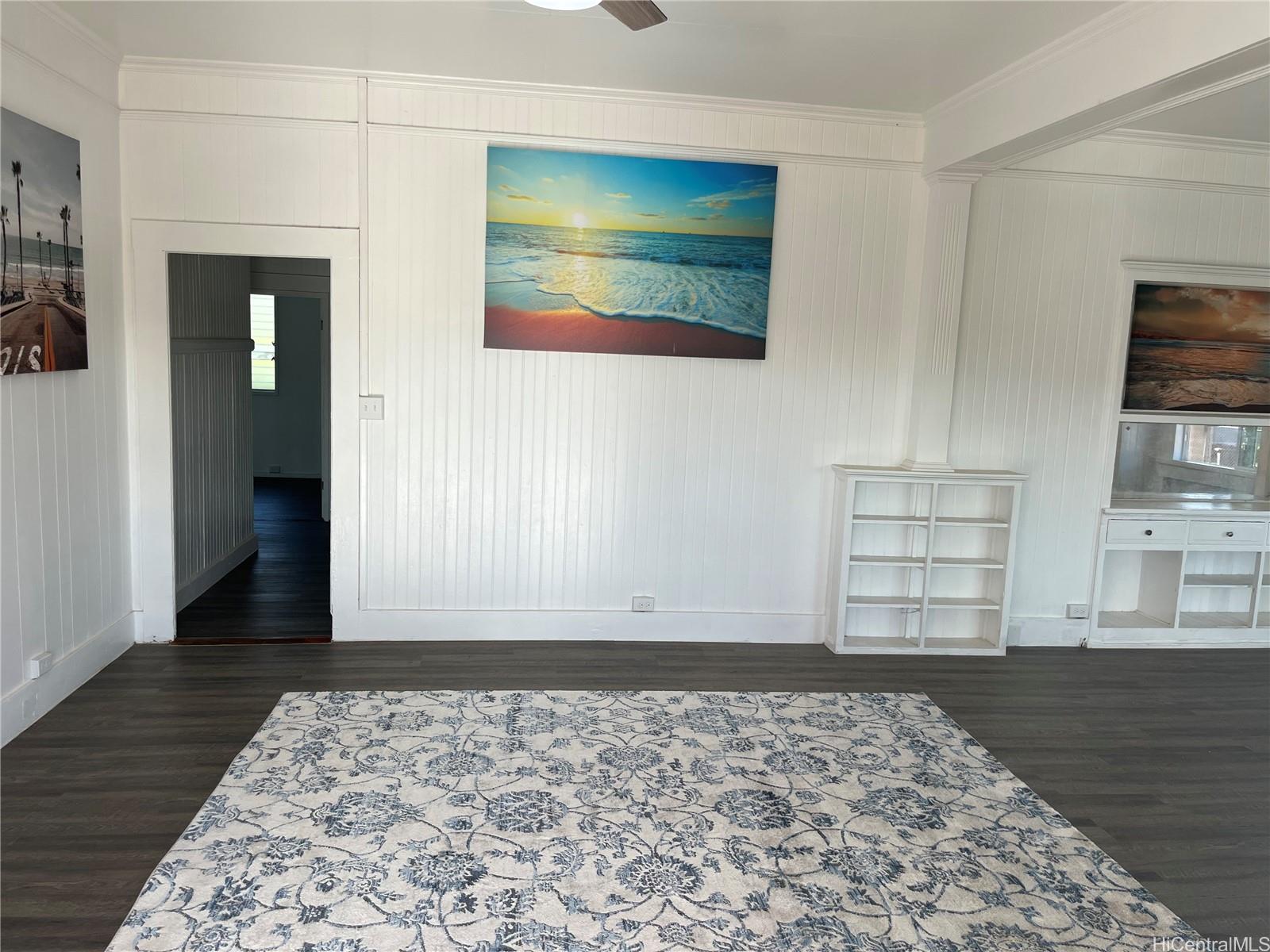 85-824 Lihue Street Waianae, HI 96792 - Photo 13 of 21 a view of an empty room with wooden floor and a window