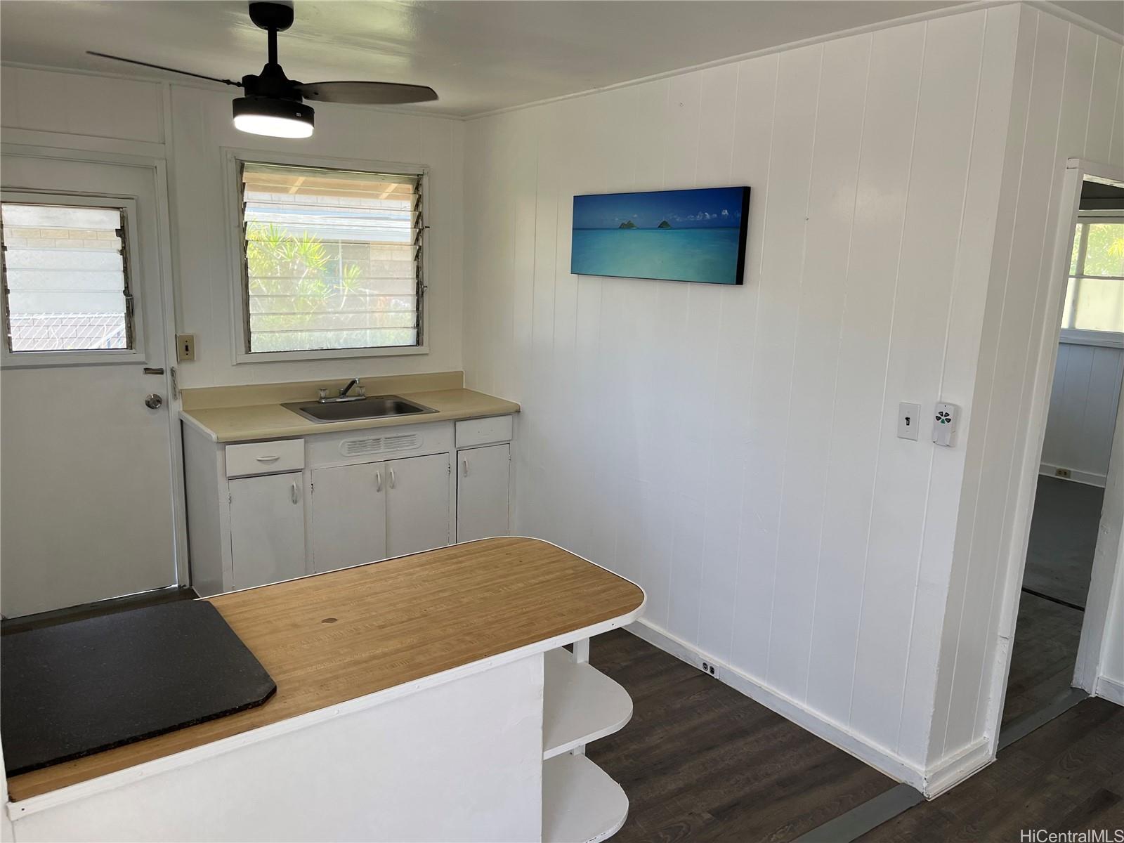 85-824 Lihue Street Waianae, HI 96792 - Photo 19 of 21 a kitchen with a sink a window and wooden floor