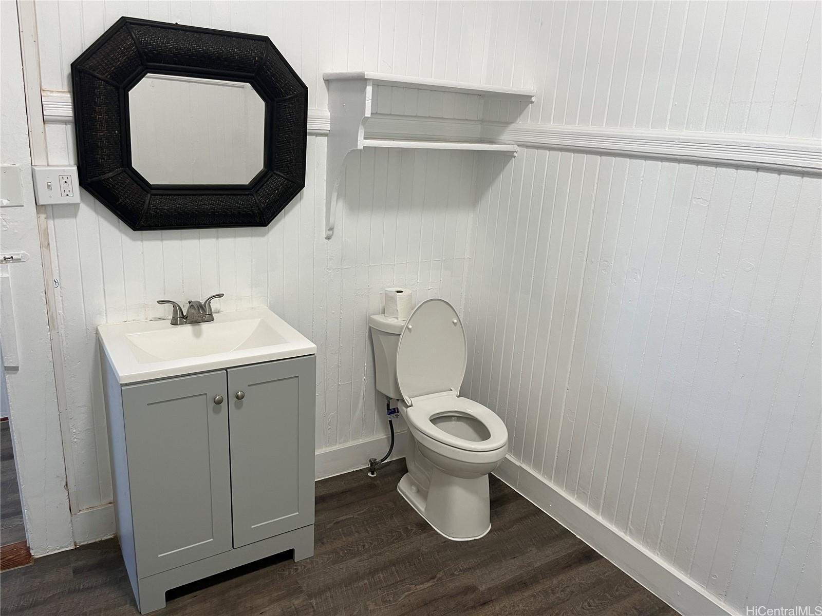 85-824 Lihue Street Waianae, HI 96792 - Photo 7 of 21 a white toilet sitting next to a bathroom sink
