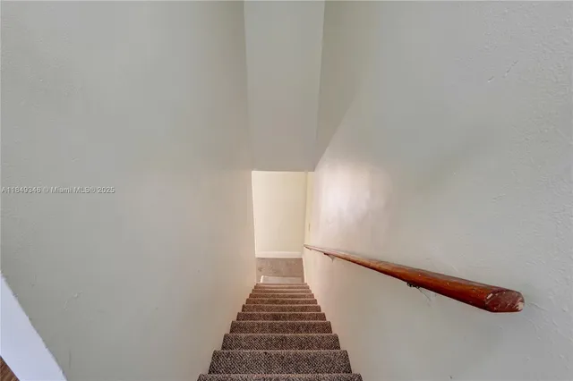 a view of a hallway with stairs