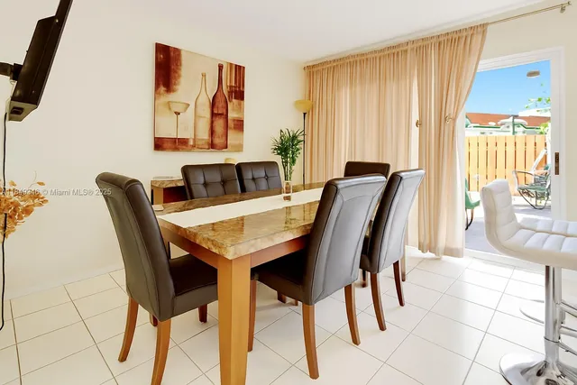 a view of a dining room with furniture and a window