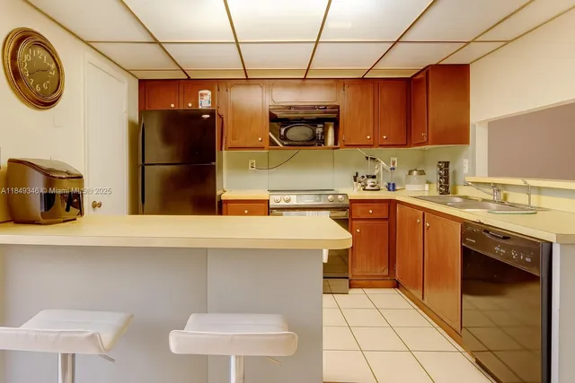a kitchen with a sink a stove top oven and cabinets