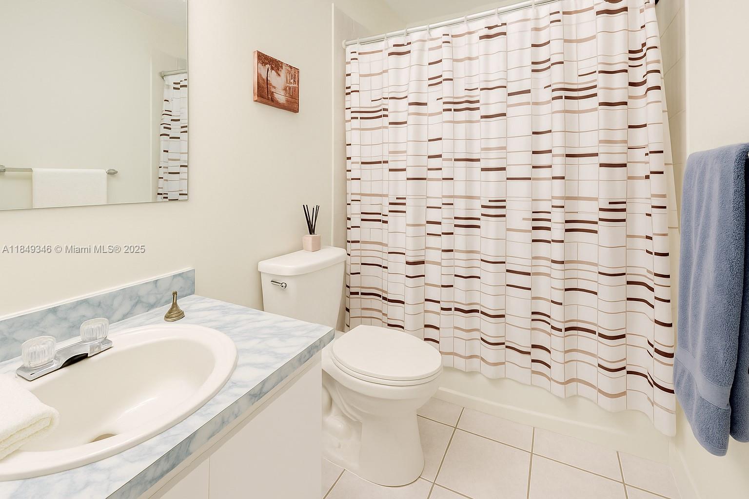 13731 Southwest 84th Street, Unit B Miami, FL 33143 - Photo 7 of 13 a bathroom with a sink toilet and shower