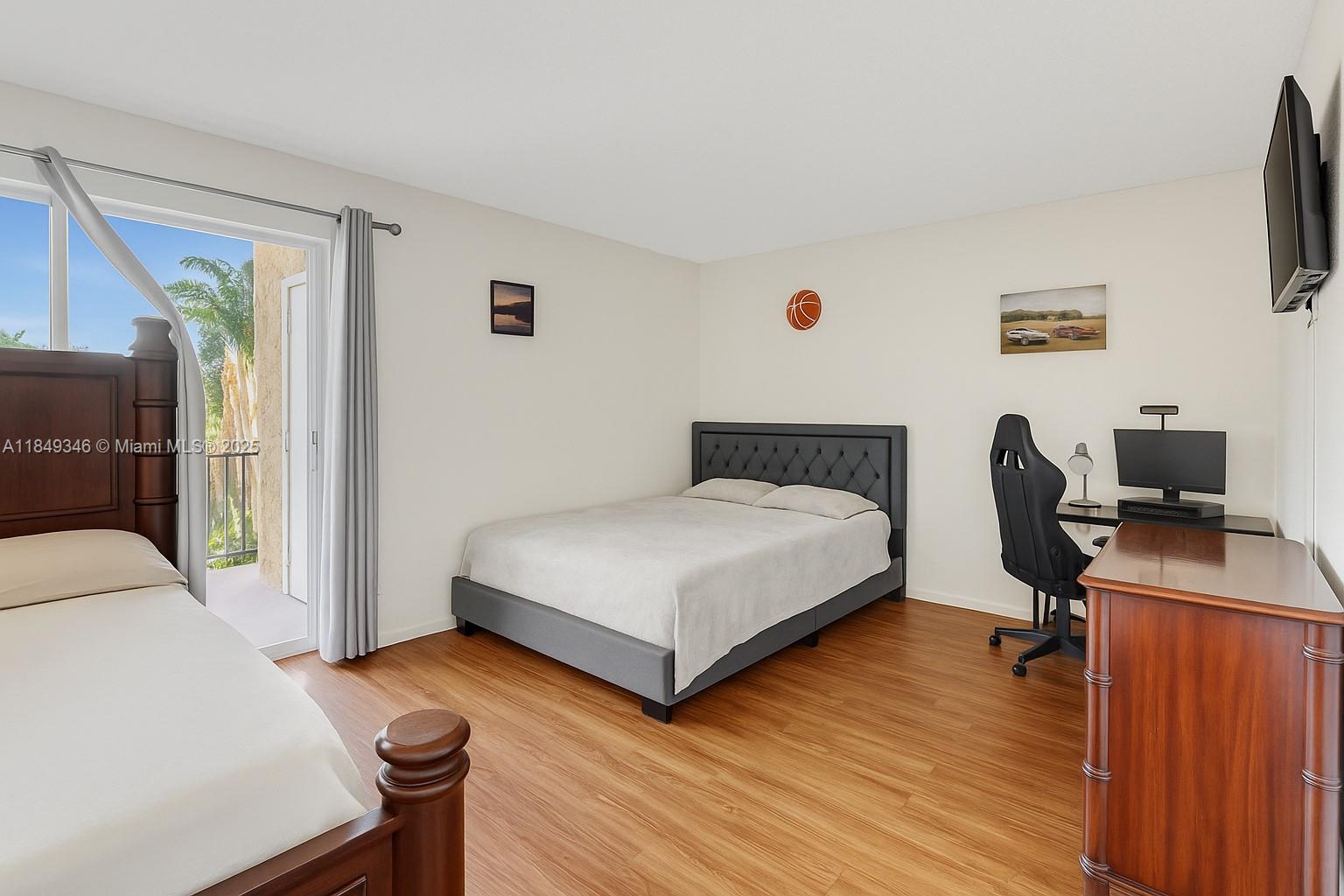 13731 Southwest 84th Street, Unit B Miami, FL 33143 - Photo 10 of 13 a bedroom with a bed and a desk