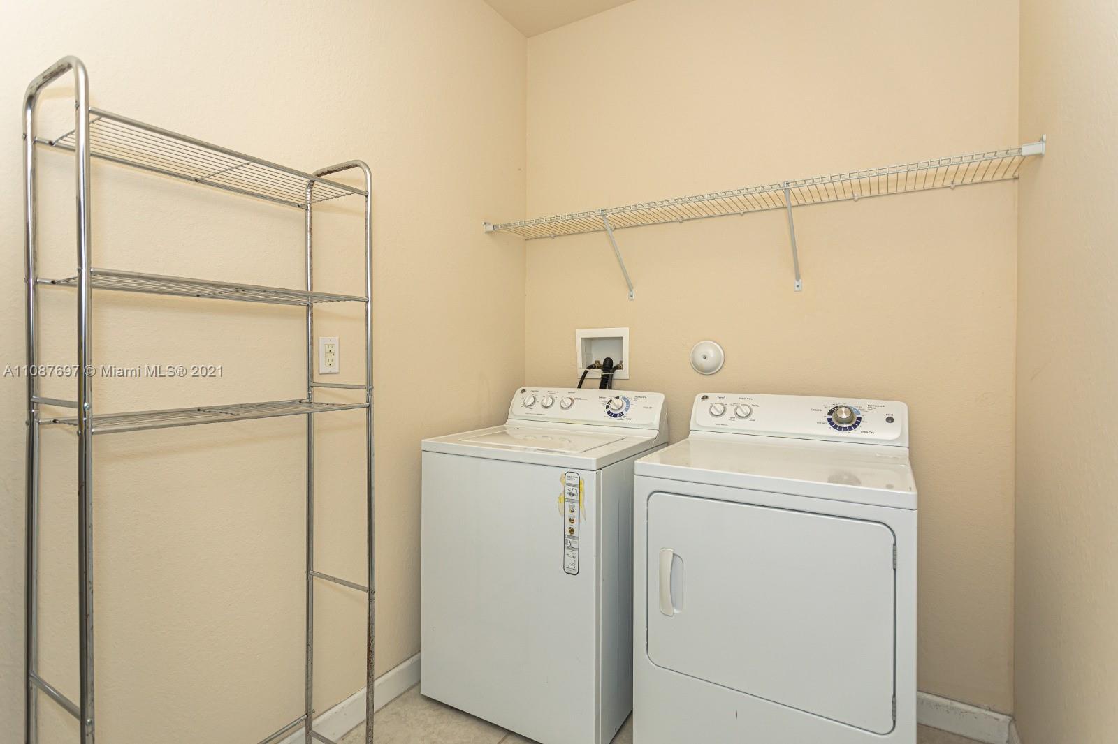 9019 Southwest 227th Terrace Cutler Bay, FL 33190 - Photo 3 of 9 a utility room with dryer and washer