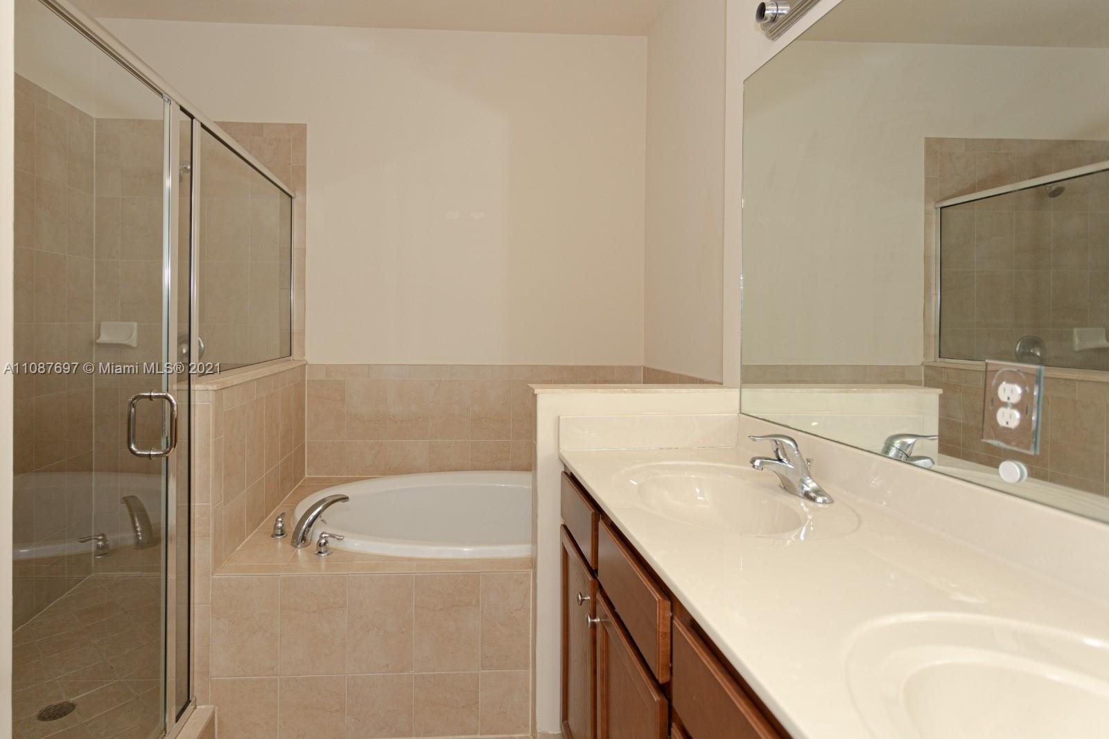 9019 Southwest 227th Terrace Cutler Bay, FL 33190 - Photo 7 of 9 a bathroom with a sink a toilet and shower
