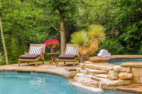 a view of a swimming pool with an outdoor space and seating area