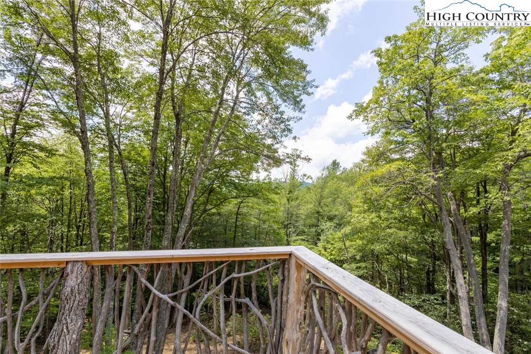 141 Rhododendron Drive Beech Mountain, NC 28604 - Photo 13 of 27 a view of trees and deck in the background