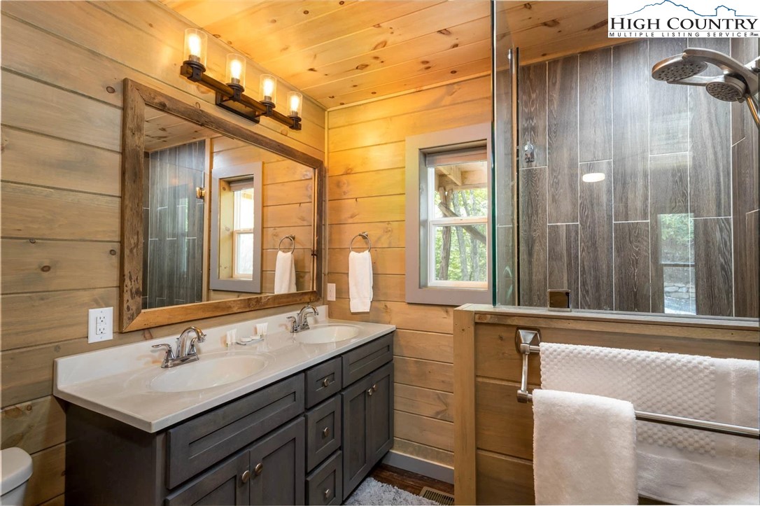 141 Rhododendron Drive Beech Mountain, NC 28604 - Photo 17 of 27 a bathroom with a sink and a mirror