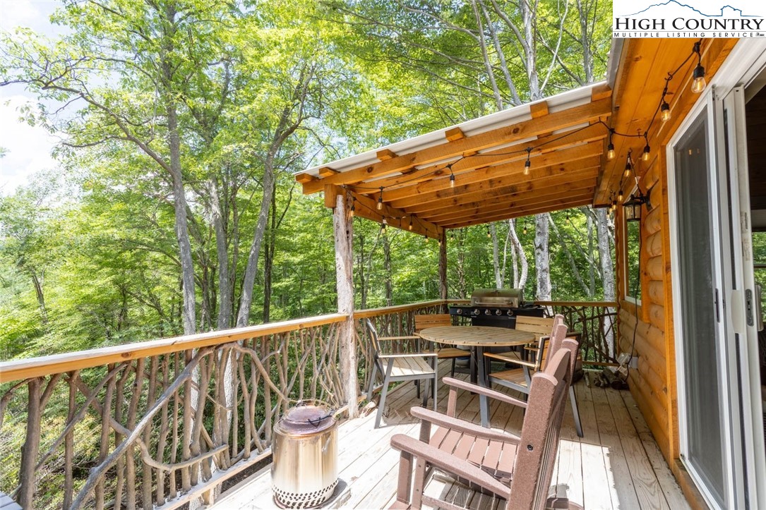 141 Rhododendron Drive Beech Mountain, NC 28604 - Photo 20 of 27 a view of a chair and tables in the balcony