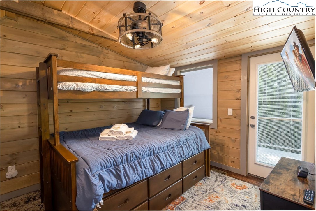 141 Rhododendron Drive Beech Mountain, NC 28604 - Photo 22 of 27 a bedroom with a bed and wooden floor