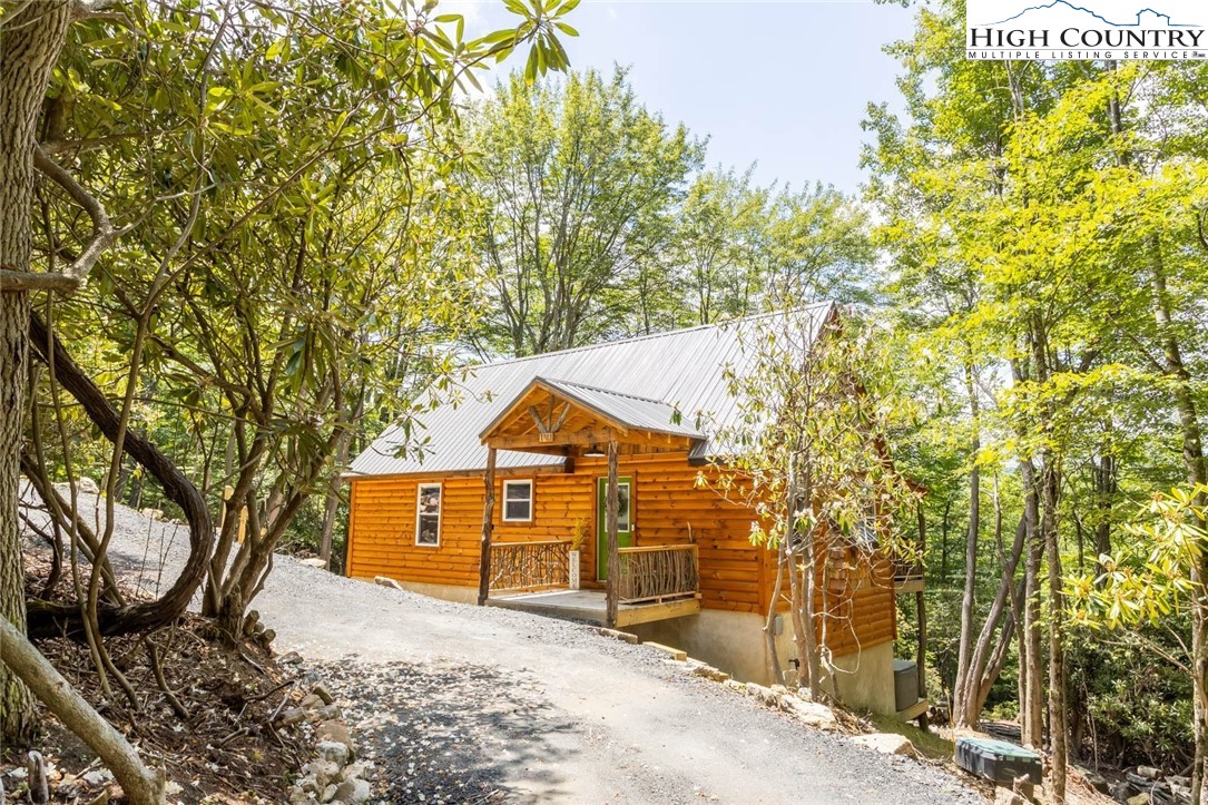 141 Rhododendron Drive Beech Mountain, NC 28604 - Photo 3 of 27 a view of a house with a yard