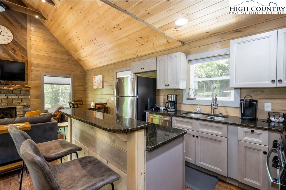 141 Rhododendron Drive Beech Mountain, NC 28604 - Photo 8 of 27 a kitchen with granite countertop a sink appliances cabinets and furniture