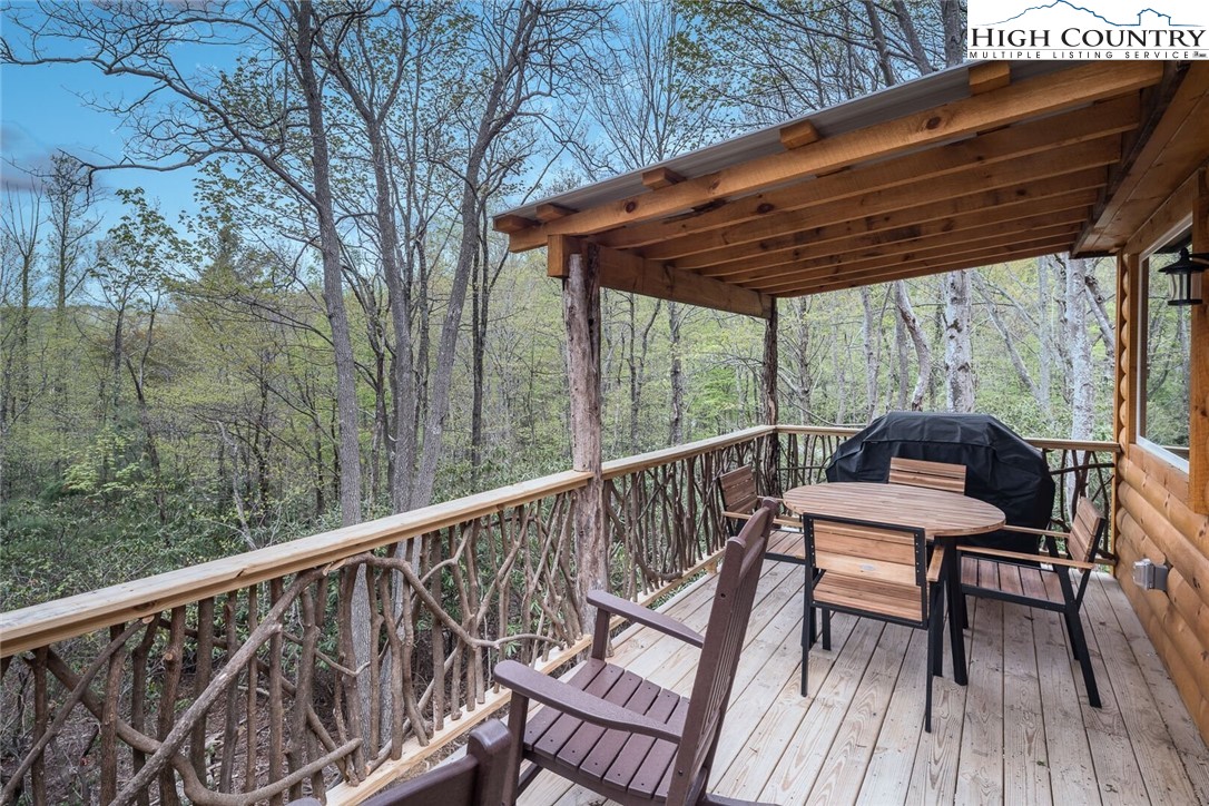 141 Rhododendron Drive Beech Mountain, NC 28604 - Photo 10 of 27 a view of a two chairs in the deck next to a yard