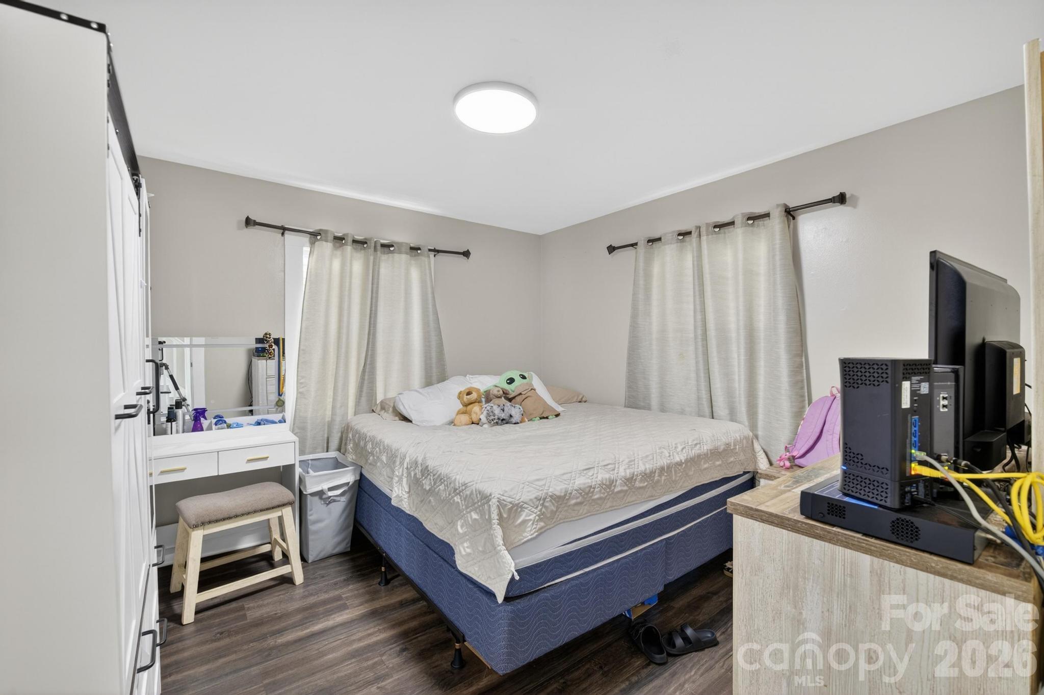2076 Connelly Springs Road Lenoir, NC 28645 - Photo 20 of 47 a bedroom with a bed and a flat screen tv