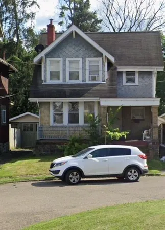 a view of a car parked in front of a house