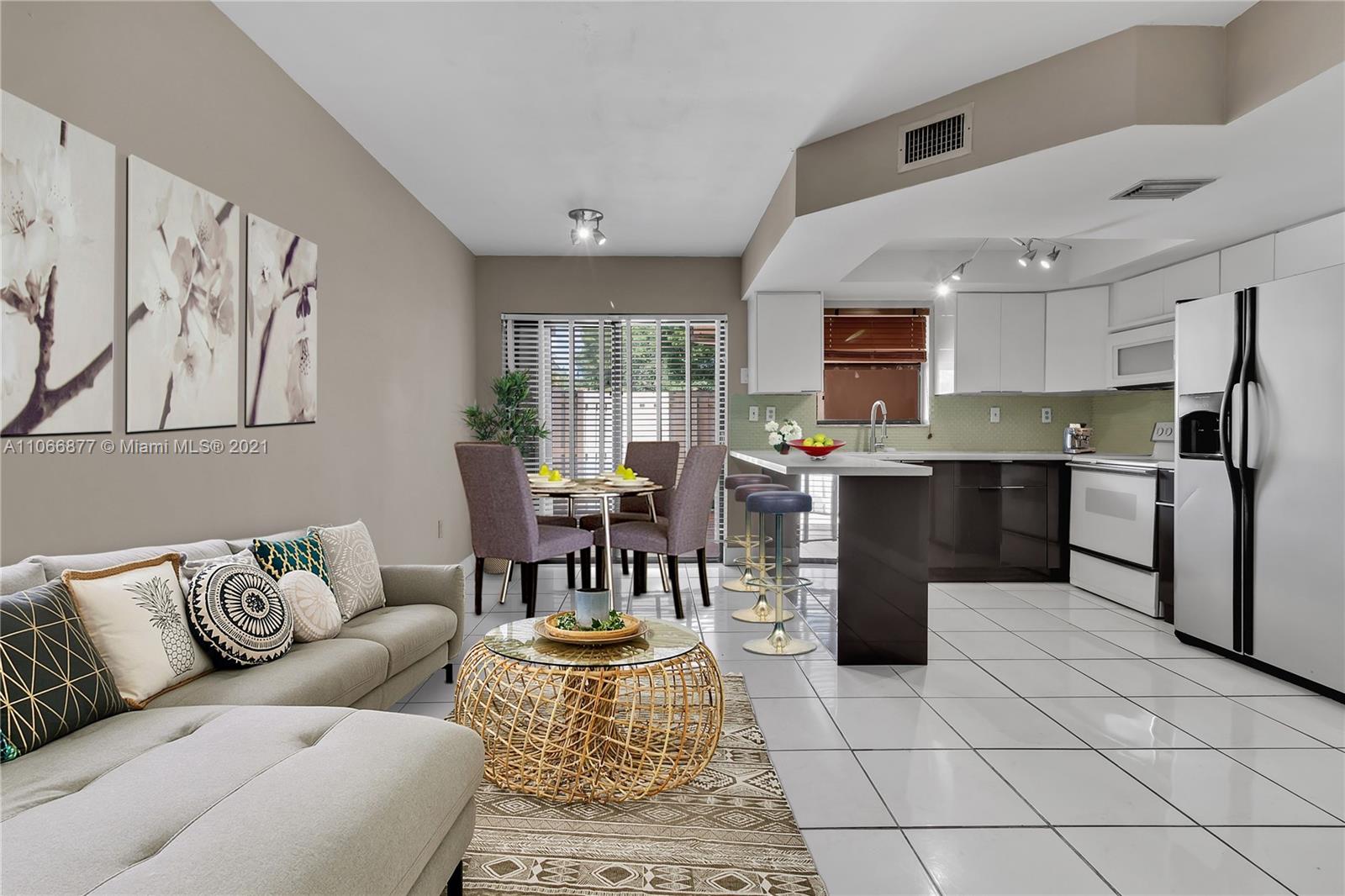 11820 Southwest 80th Street, Unit 312 Miami, FL 33183 - Photo 11 of 43 a living room with furniture and kitchen view