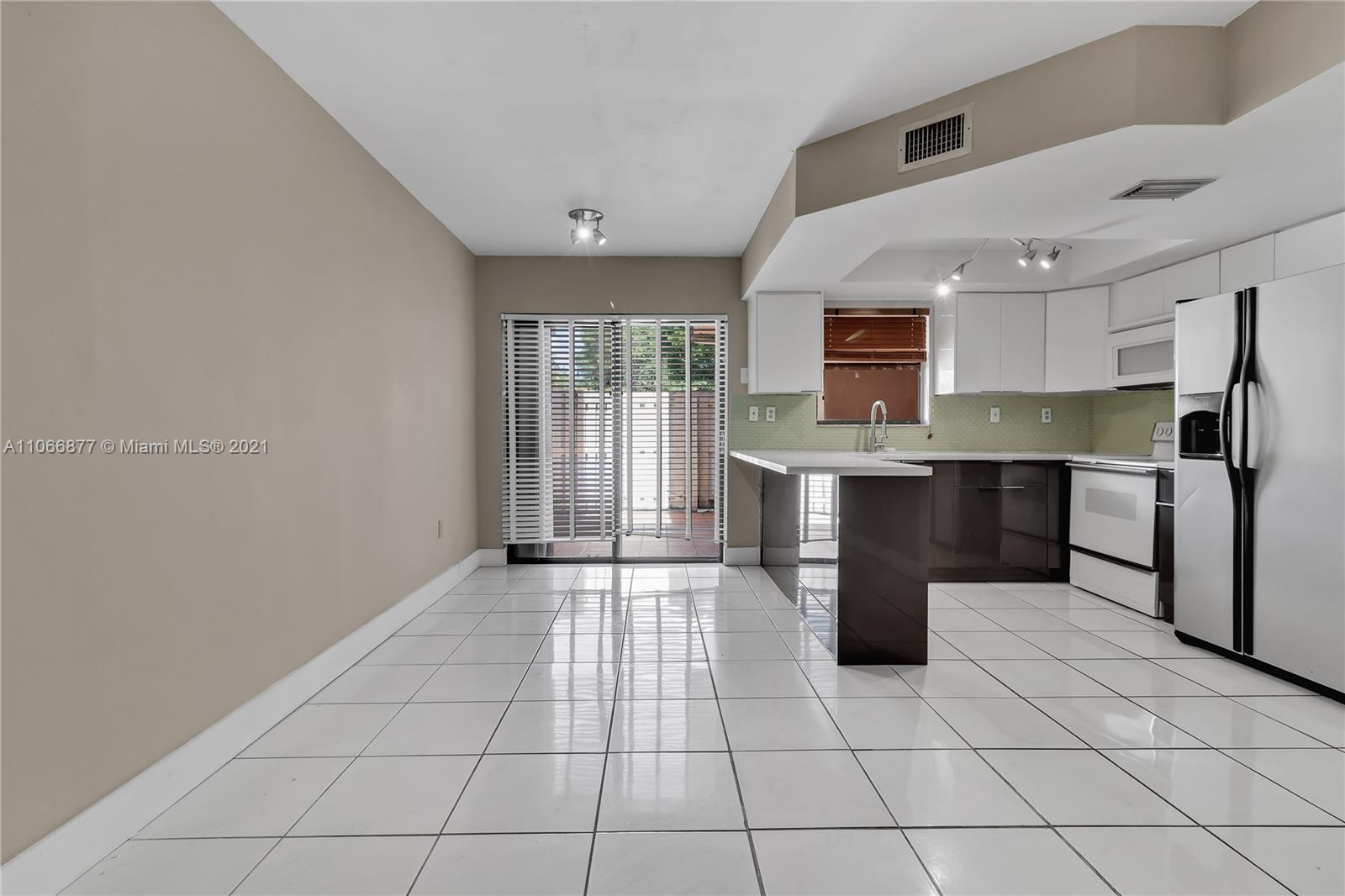 11820 Southwest 80th Street, Unit 312 Miami, FL 33183 - Photo 12 of 43 a kitchen with stainless steel appliances a refrigerator sink and cabinets
