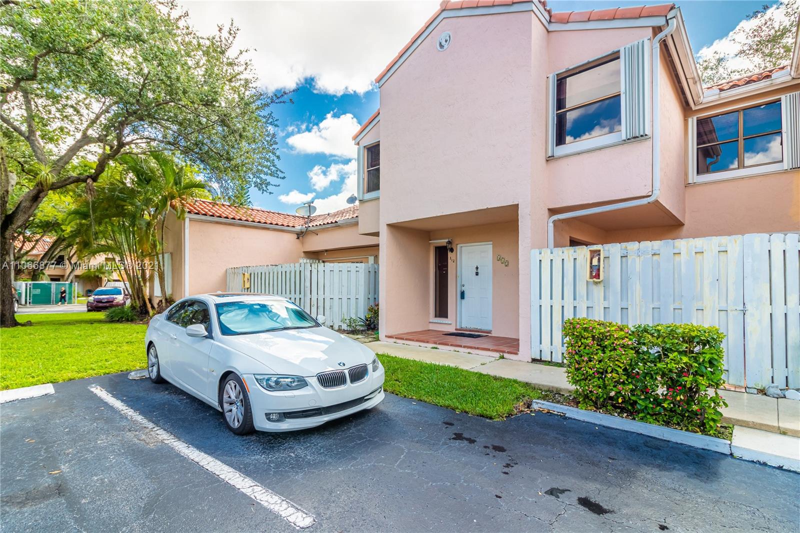 11820 Southwest 80th Street, Unit 312 Miami, FL 33183 - Photo 2 of 43 a car parked in front of a house