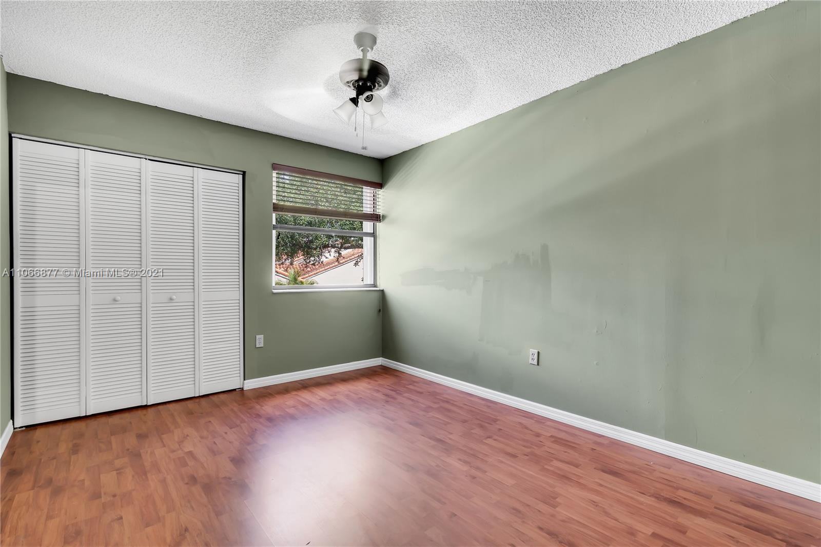 11820 Southwest 80th Street, Unit 312 Miami, FL 33183 - Photo 21 of 43 wooden floor in an empty room