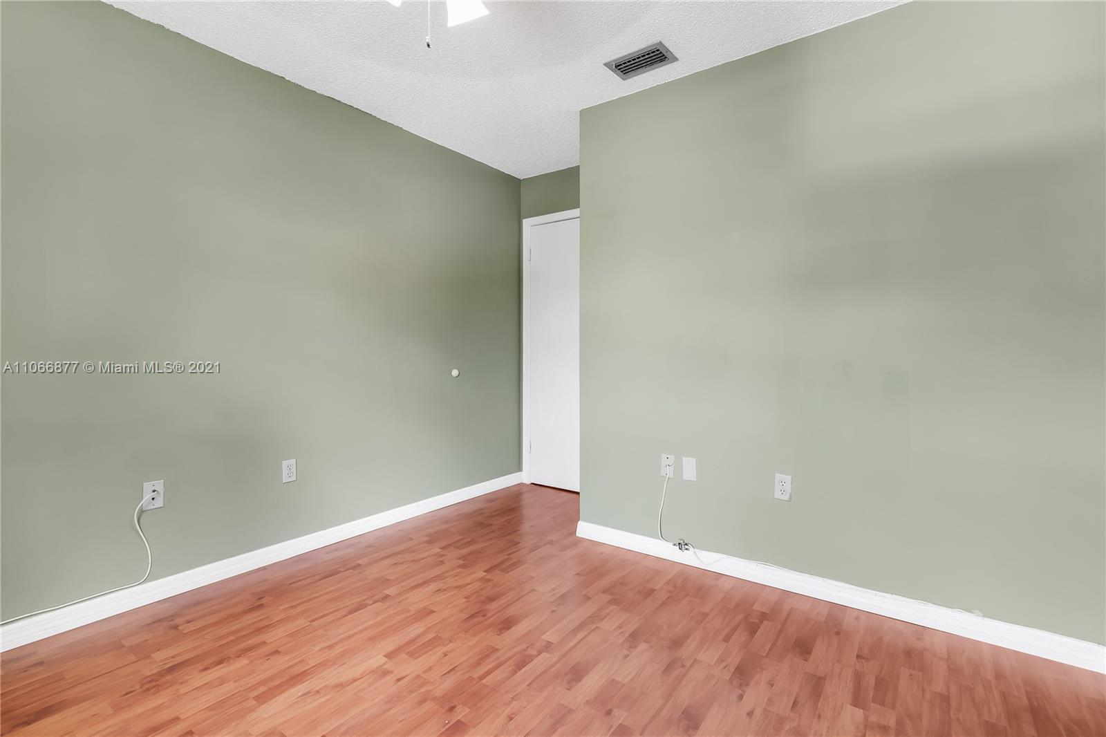 11820 Southwest 80th Street, Unit 312 Miami, FL 33183 - Photo 24 of 43 a view of an empty room with wooden floor