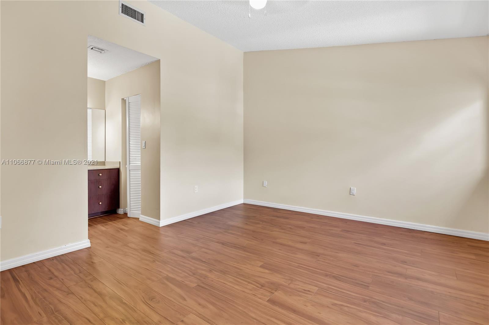 11820 Southwest 80th Street, Unit 312 Miami, FL 33183 - Photo 27 of 43 a view of an empty room with wooden floor