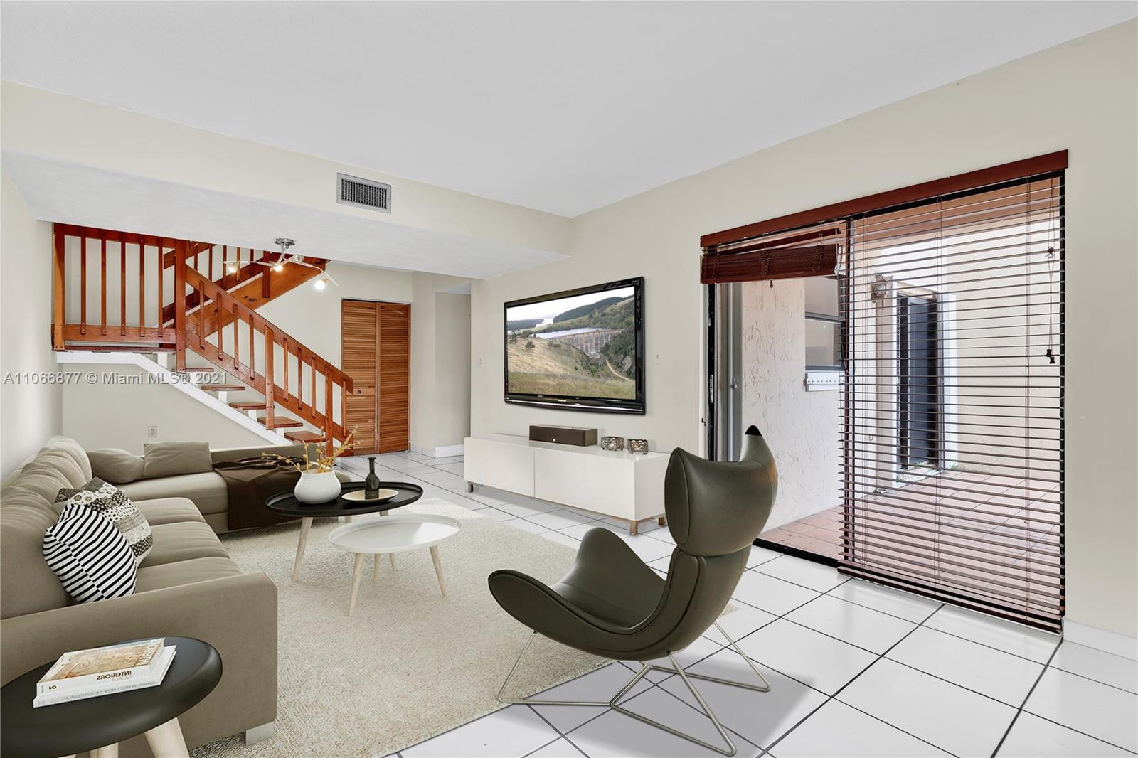 11820 Southwest 80th Street, Unit 312 Miami, FL 33183 - Photo 6 of 43 a living room with furniture and a flat screen tv