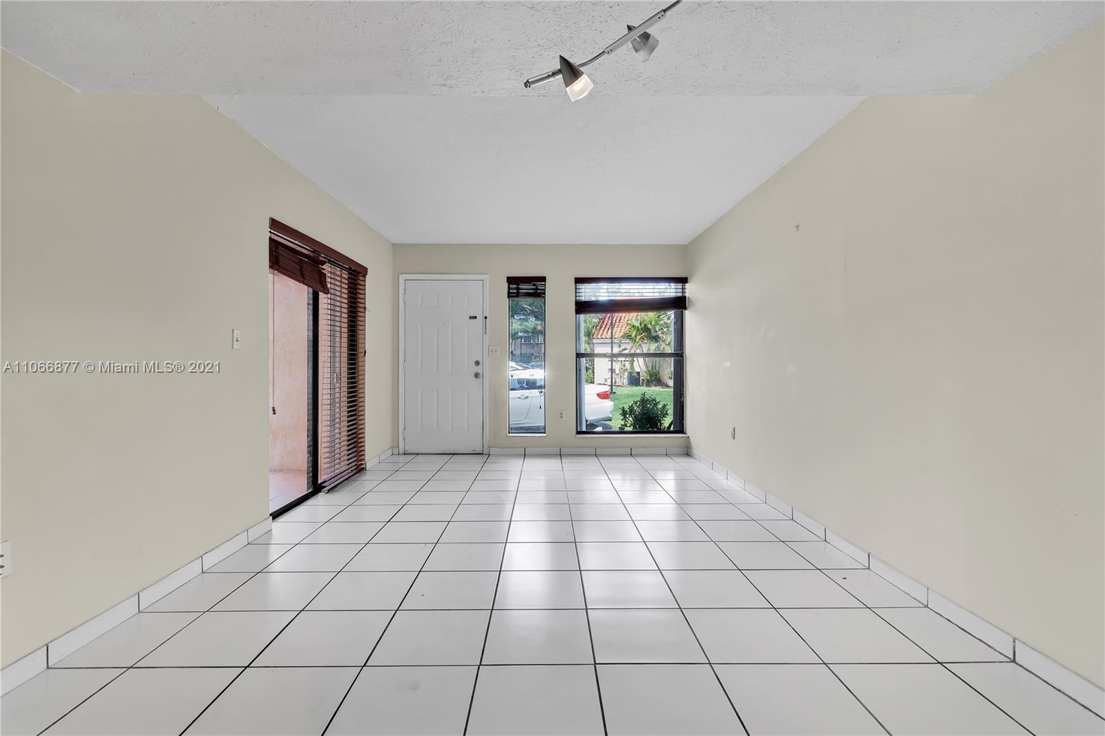 11820 Southwest 80th Street, Unit 312 Miami, FL 33183 - Photo 7 of 43 a view of an empty room and window
