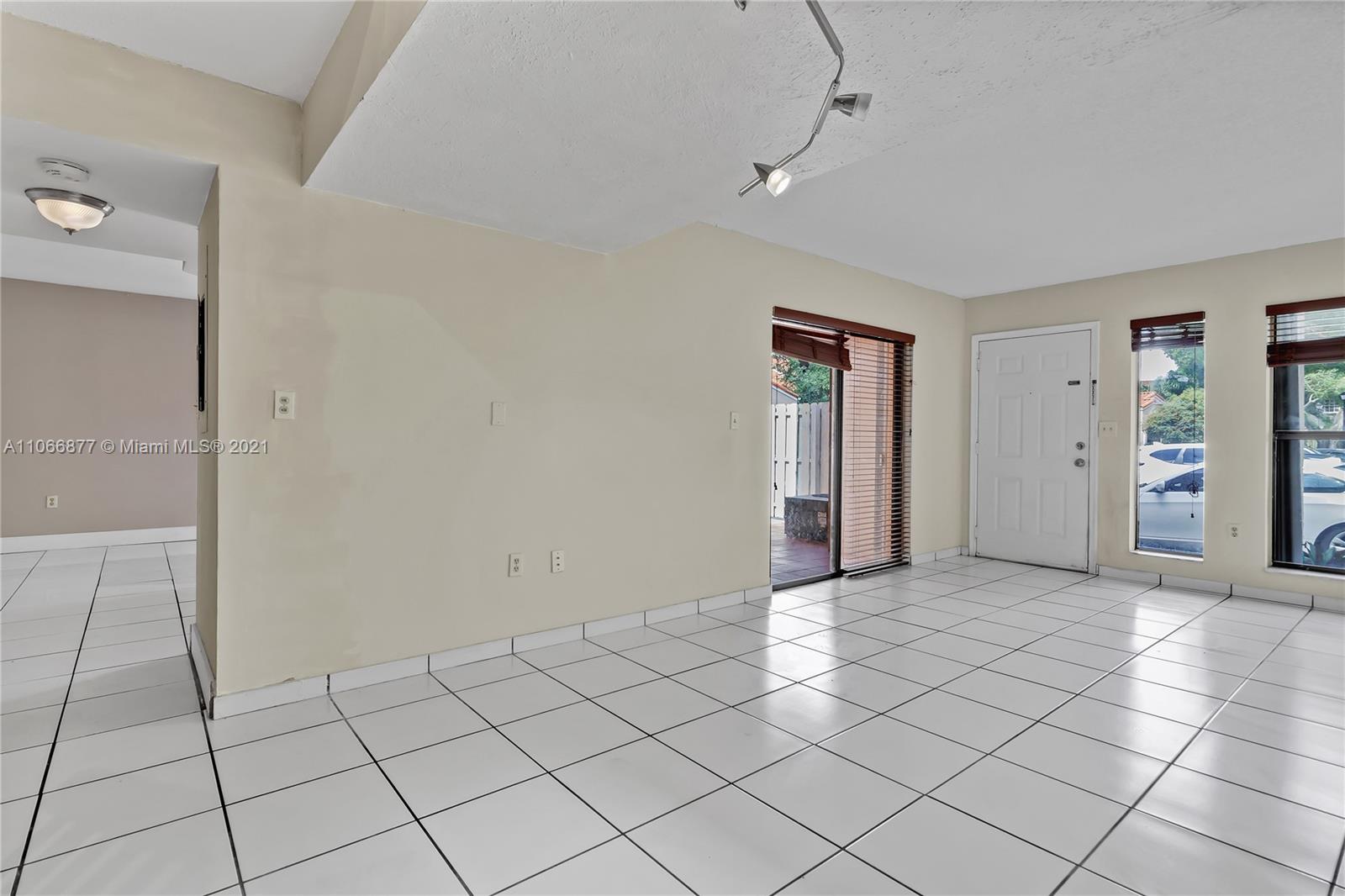 11820 Southwest 80th Street, Unit 312 Miami, FL 33183 - Photo 9 of 43 a view of an empty room and window