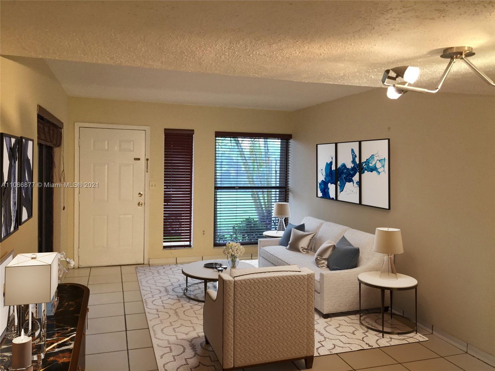 11820 Southwest 80th Street, Unit 312 Miami, FL 33183 - Photo 10 of 43 a living room with couches a fireplace and a dining table with wooden floor