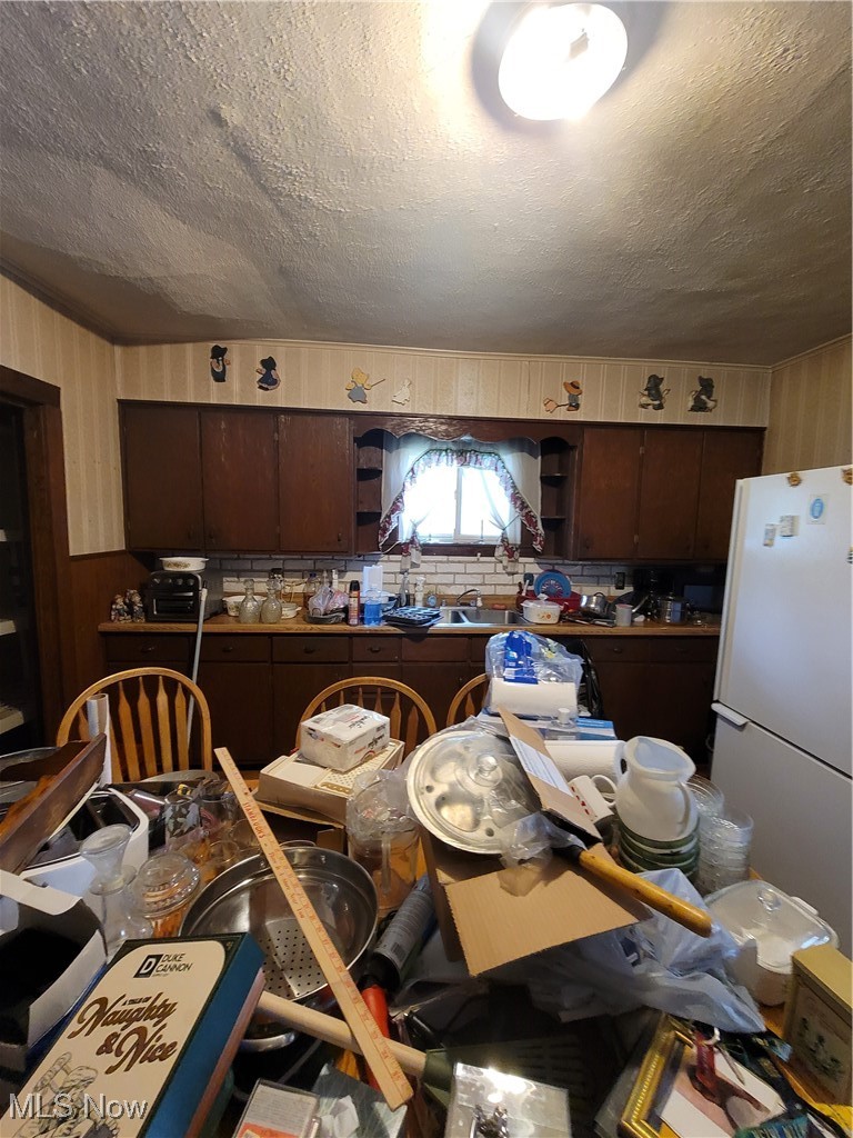 145 North Road Niles, OH 44446 - Photo 14 of 24 Kitchen featuring refrigerator, open shelves, a textured ceiling, and dark brown cabinets