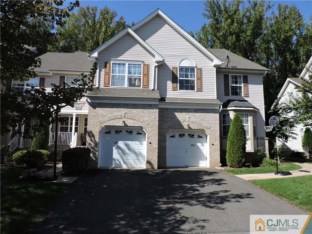 236 Hawthorne Road North Brunswick, NJ 08902 - Photo 1 of 25 a front view of a house with a yard and garage