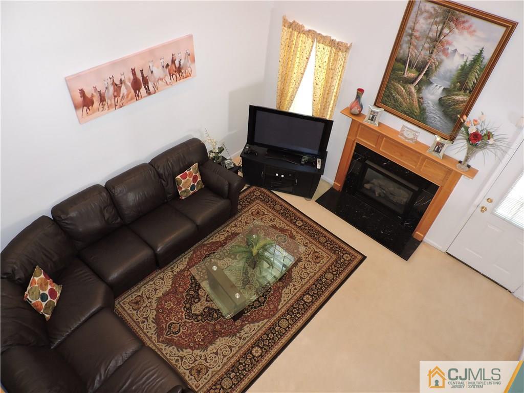 236 Hawthorne Road North Brunswick, NJ 08902 - Photo 11 of 25 a living room with furniture and a fireplace