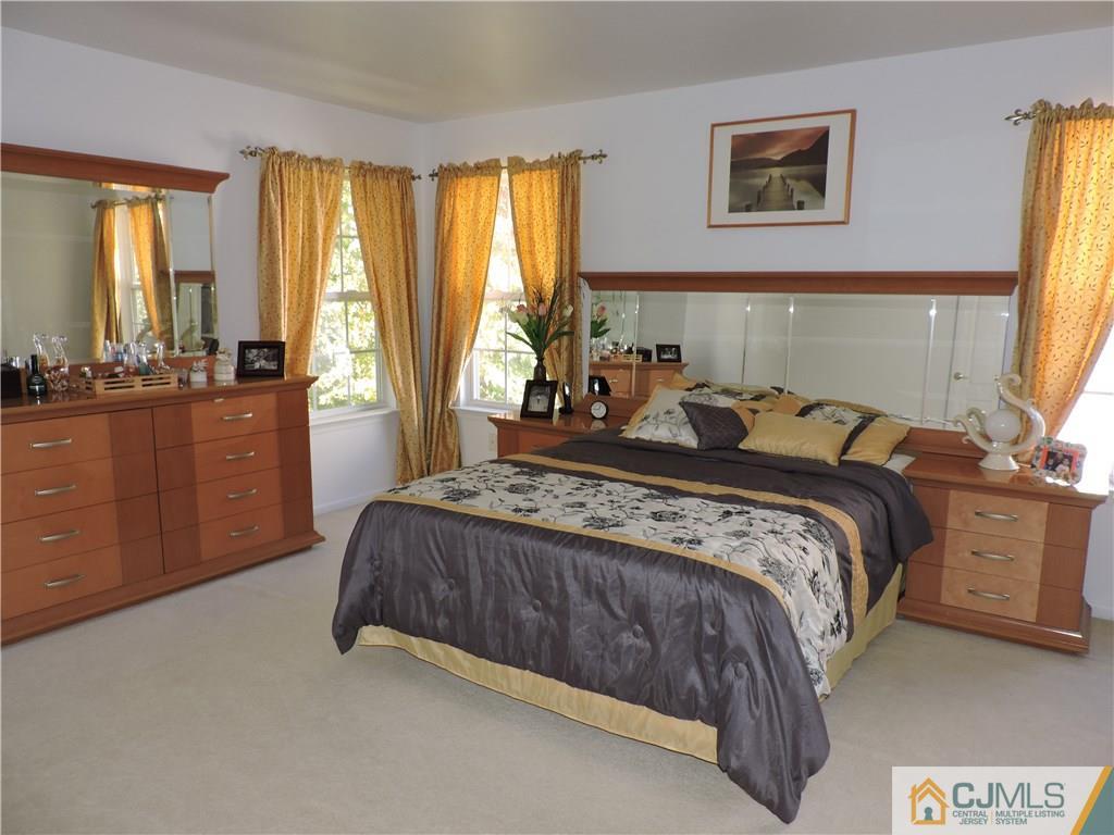 236 Hawthorne Road North Brunswick, NJ 08902 - Photo 12 of 25 a bed room with a bed and a dresser