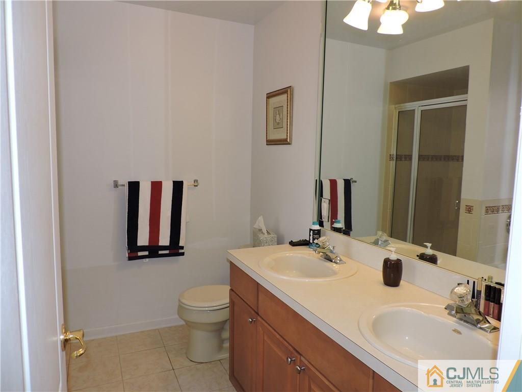 236 Hawthorne Road North Brunswick, NJ 08902 - Photo 13 of 25 a bathroom with a granite countertop sink a toilet and a mirror