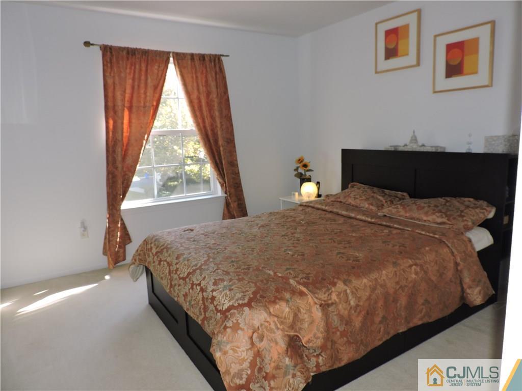 236 Hawthorne Road North Brunswick, NJ 08902 - Photo 15 of 25 a bed sitting in a bedroom next to a window