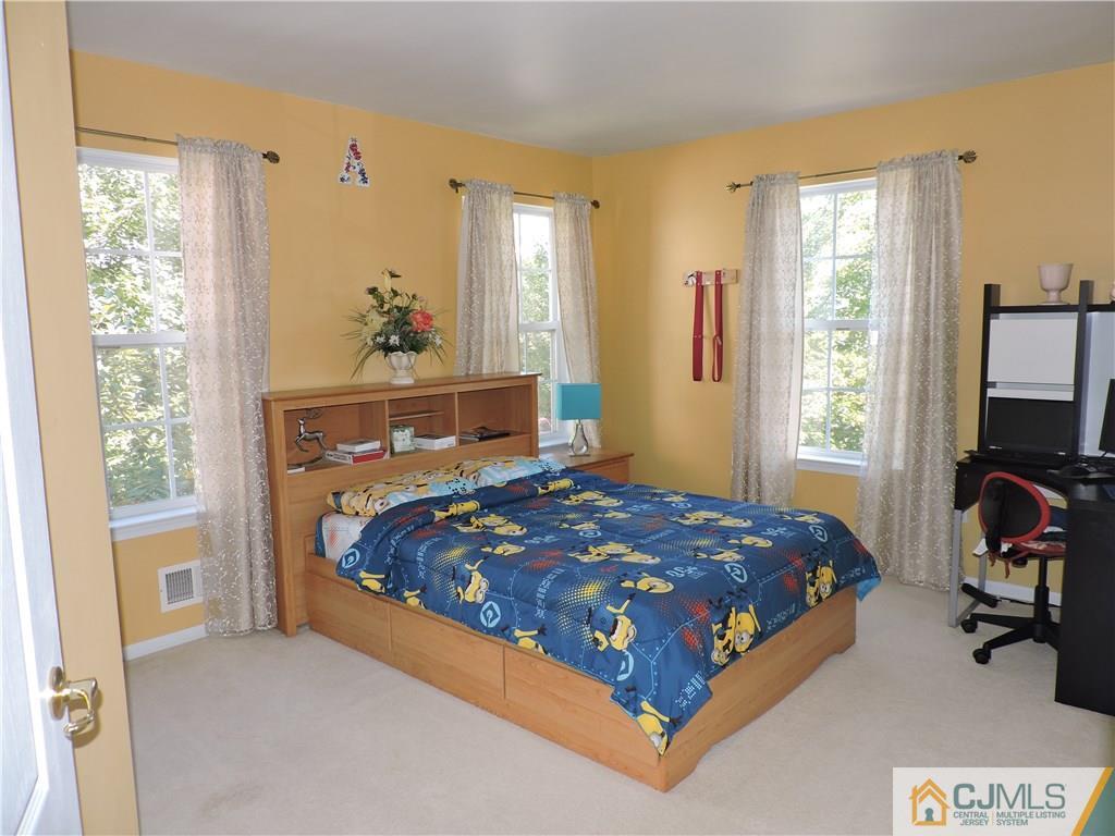 236 Hawthorne Road North Brunswick, NJ 08902 - Photo 16 of 25 a bed sitting in a bedroom next to a window