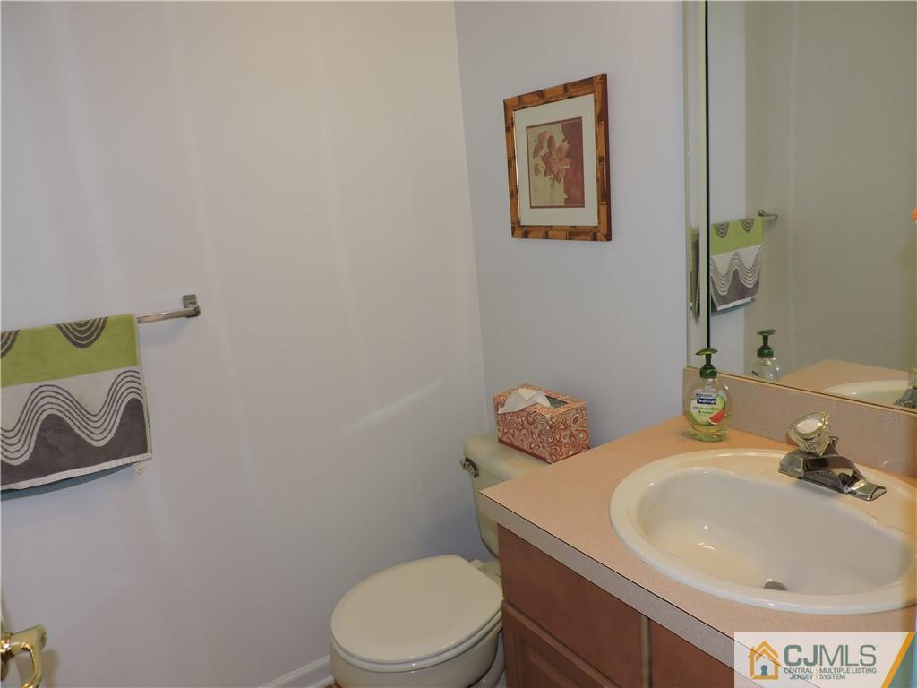 236 Hawthorne Road North Brunswick, NJ 08902 - Photo 21 of 25 a bathroom with a toilet sink and mirror