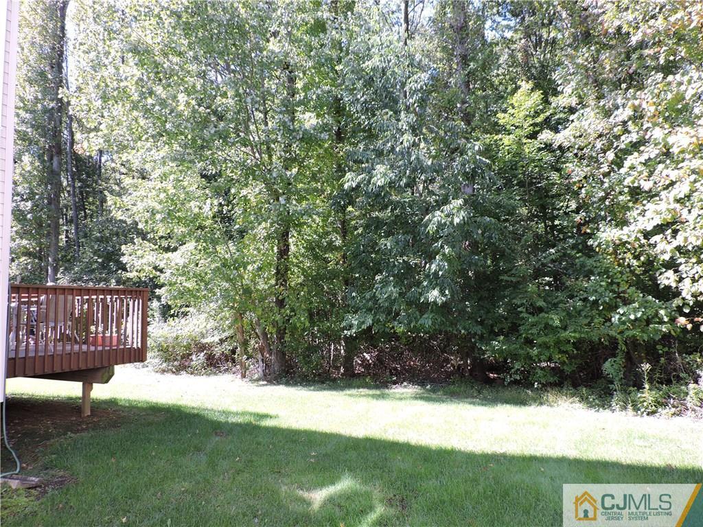 236 Hawthorne Road North Brunswick, NJ 08902 - Photo 24 of 25 a view of yard with large trees and wooden fence
