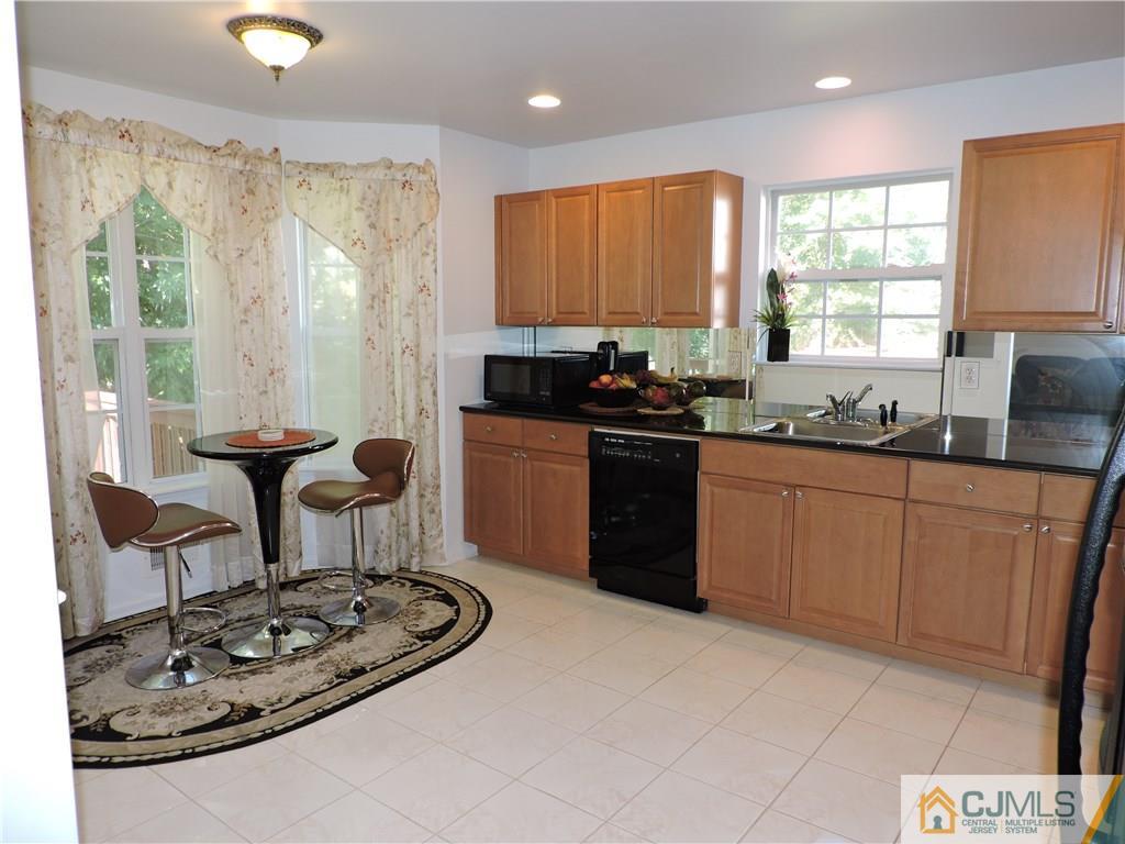 236 Hawthorne Road North Brunswick, NJ 08902 - Photo 7 of 25 a kitchen with stainless steel appliances granite countertop a sink stove and cabinets